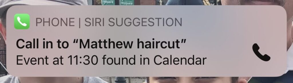 iPhone notification suggesting I "call in" to my haircut and a phone icon. 