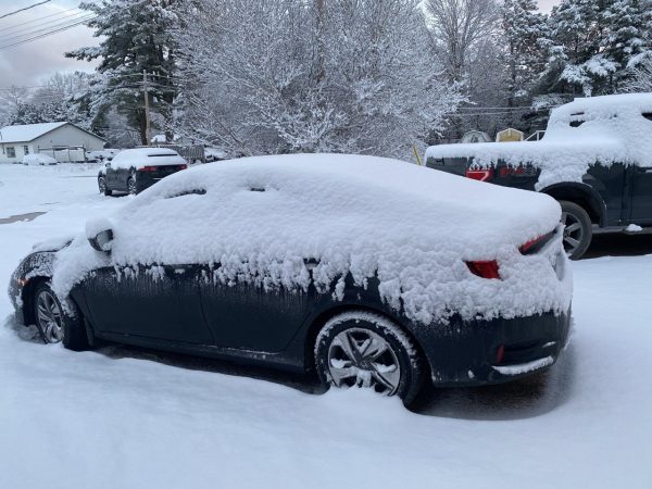 Black Honda Civic covered in snow